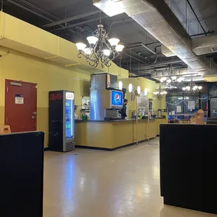 View of counter and booths. Not in view, tv and colorful lights