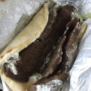 Gyro, lots of meat, lettuce and tomato underneath