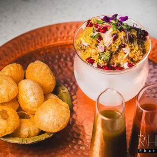 a bowl of food on a copper tray