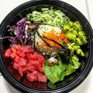 Sushi Bowl with white rice, red cabbage, cucumber, mixed greens, avocado, dried seaweed, masago and tuna
