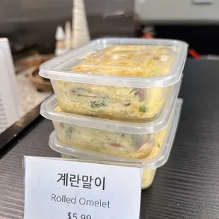 three plastic containers of food on a counter
