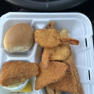 2 shrimp and 2 fish with 3 potato wedges, roll and tartar sauce