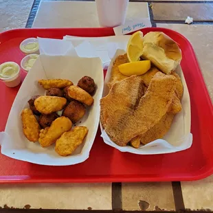 Fried snapper, potato wedges, hush puppies and jalapeno peppers.