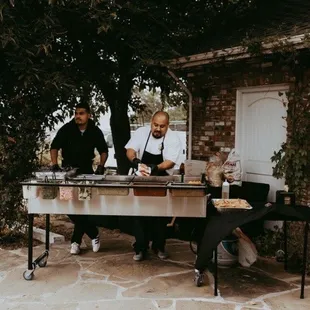 a man and a woman preparing food outside