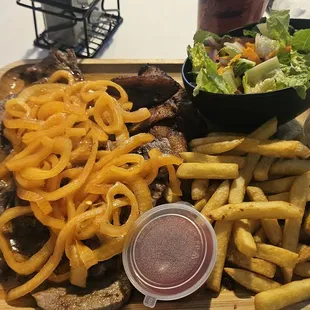 Steak, fried plantains, fries, and a side salad