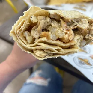 a hand holding a taqueria