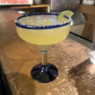 a margarita with a lime wedge
