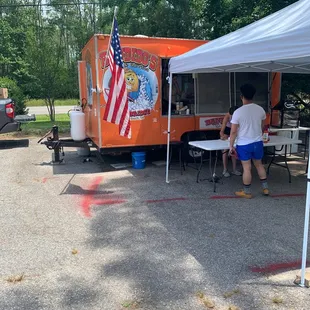 a man and woman standing under a tent