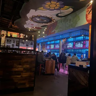 Inside the restaurant from the front side, with view of the bar.