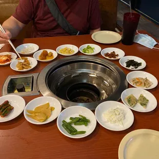 a man sitting at a table with plates of food