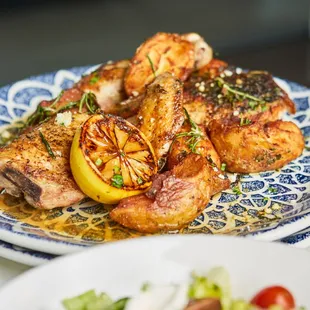 a plate of chicken and a salad