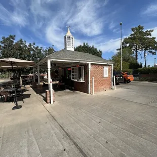 Coffee Stand with bistro tables, umbrellas, and chairs.