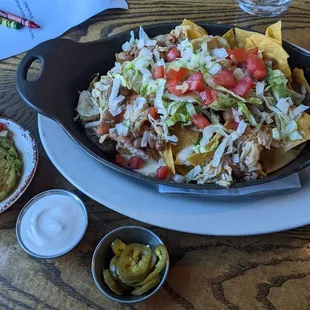 Nachos! Added green chili chicken and had guac, sour cream, jalapenos on the side