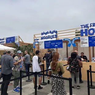 a crowd of people standing in line