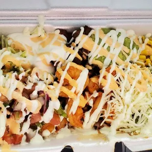 a salad in a styrofoam container