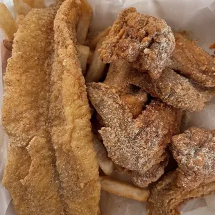 Catfish filet , wings and fries covered in sparkly spicy magic dust aka crack
