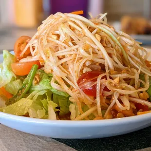 SS6. Papaya Salad. Fresh green papaya, tomatoes, carrots, peanuts, palm sugar, and lime juice. $9.