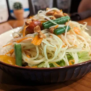 SS2. Yum Papaya Salad. $12. Bed of lettuce, fresh green papaya, tomatoes, carrots, peanuts, palm sugar, and lime juice.