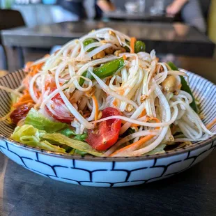 SS2. Papaya Salad. $12. Served on a bed of lettuce, fresh green papaya, tomatoes, carrots, peanuts, palm sugar and lime juice.