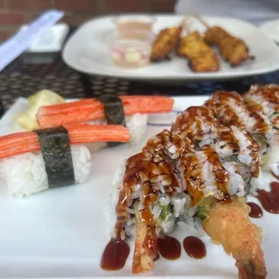 a plate of sushi and rolls