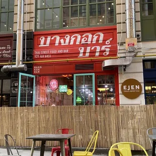 tables and chairs in front of a restaurant