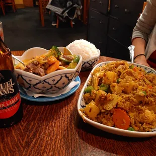 a plate of fried rice and a bottle of beer