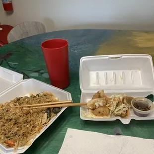 Fried rice with chicken and basil with a side of dumplings.