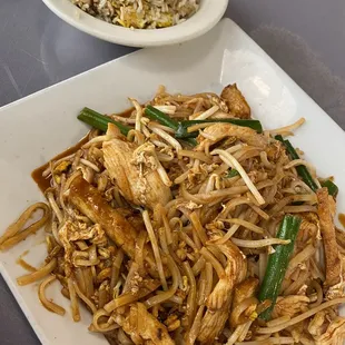 a plate of noodles and chicken