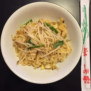 a bowl of noodles and chopsticks