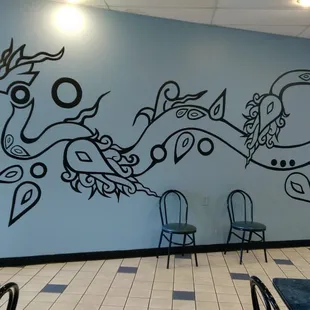 a mural of a dragon on the wall