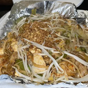 a tray of noodles with meat and vegetables