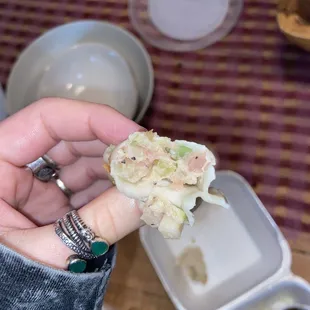 a person holding a piece of food