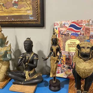 a collection of asian statues on a blue table