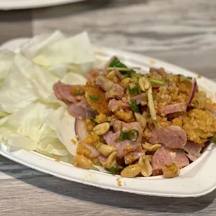 a plate of fried rice with meat and vegetables