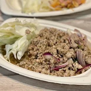 a plate of ground beef and lettuce