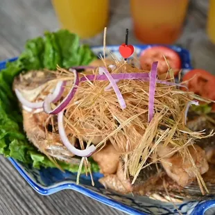 a plate of fried fish and vegetables