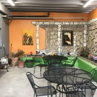 a patio with tables and chairs