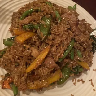 a plate of fried rice and vegetables