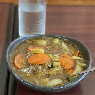 a bowl of soup and a bottle of water