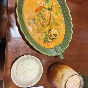 a bowl of soup, rice, and bread