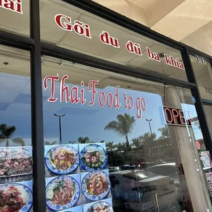 the front window of a thai food shop