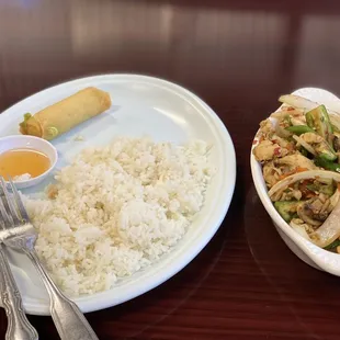a plate of rice and a bowl of stir fried vegetables