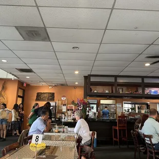 a view of a restaurant with people sitting at tables