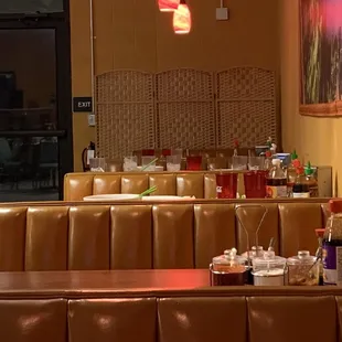 Dirty tables, unbussed, in an empty restaurant.