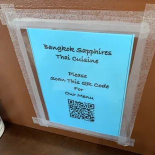 a blue sign on a brown wall