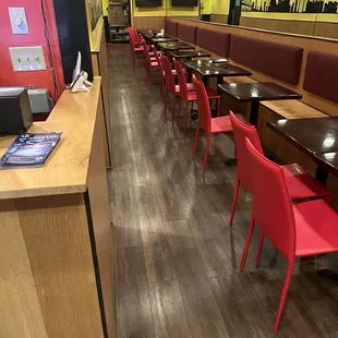 a row of tables and chairs in a restaurant