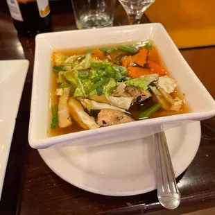 a bowl of soup and a glass of water