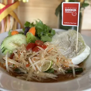 a plate of food with a sign on it