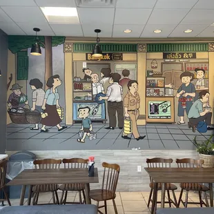 a restaurant with a mural on the wall