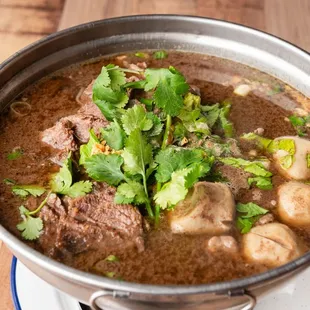 a pot of beef and mushrooms